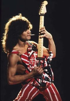 a man with an american flag shirt holding a guitar