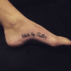 a foot with the words walk by faith tattooed on it's left side leg