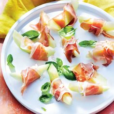 small appetizers are arranged on a white plate