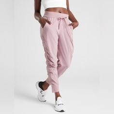 Attitude Pant From Athleta In A Pink Sugarplum Mauve Color, Size 2. New With Tags! Jogger Style Pants With Drawstring And Side Ruching. Spring Athleisure Bottoms For Running, Athleisure Bottoms For Running, Spring Athleisure Running Bottoms, Fitted Casual Joggers For Running, Casual Fitted Joggers For Running, Casual Purple Workout Bottoms, Pink Casual Sweatpants For Yoga, Spring Running Activewear With Pockets, Pink Athleisure Yoga Pants With Elastic Waistband