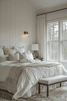 a large bed sitting next to a window in a bedroom