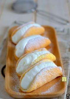 several pastries on a plate with powdered sugar