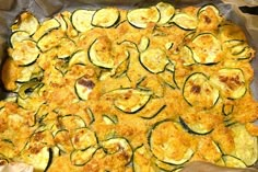 zucchini and cheese casserole in a pan on top of wax paper