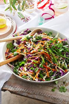 a salad with carrots, broccoli and radishes in a bowl