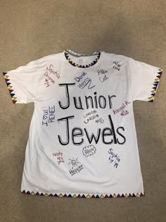 a white t - shirt with the words junior jewels written on it in many different languages