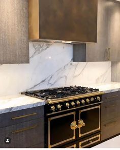 a stove top oven sitting inside of a kitchen next to a wall mounted range hood