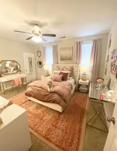 a bed room with a neatly made bed and a rug in front of a window