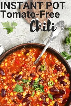 instant pot tomato - free chili in a bowl with a spoon and cilantro on the side