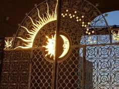 an iron gate with the sun and moon on it