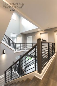 an open floor plan with stairs and railings