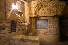 an old stone room with writing on the walls