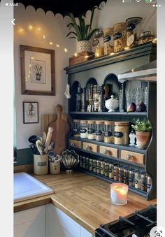 a kitchen with lots of pots and pans on the shelves