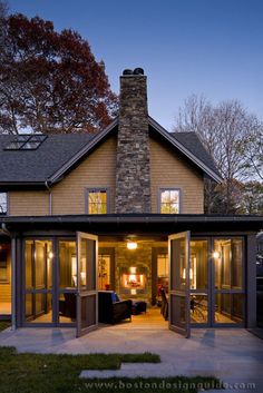 a large house with lots of windows on the front and back doors open to let in light