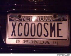 a close up of a license plate on a car's hood with the words xcoose me