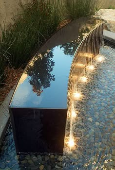 a water feature with lights on the sides