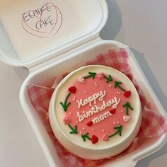 a birthday cake in a plastic container with the words happy birthday mom written on it