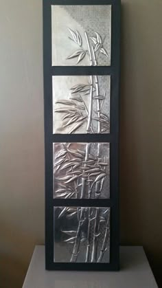 three panels are shown in the shape of bamboos and leaves on a white surface