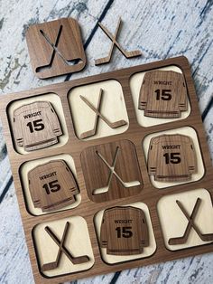 a wooden clock with different numbers on it and two crossed crosses in the middle, sitting on top of a table