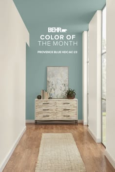 a hallway painted in blue and white with the words behr color of the month above it