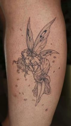 a tattoo with a fairy on it's thigh and a flower in the middle