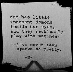 an old typewriter with the words she has little innocent demons inside her eyes and they recklessly play with matches