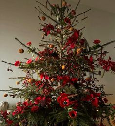 a christmas tree decorated with red and gold ornaments