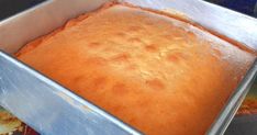 a metal pan filled with cake batter on top of a counter next to other baking supplies