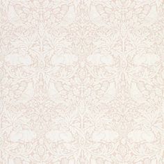 a white rug with an intricate design on the bottom and side, in front of a light pink background