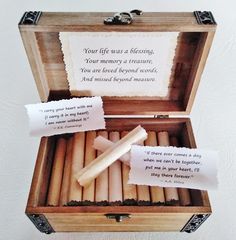 a wooden box filled with lots of different types of candles next to some paper on top of it