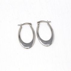 Trendy modern circa 2000's era estate 14k white gold hoop earrings! This classic oval style pair are free of design, and secure with latch back earring closures. These elongated hoops are comfortably lightweight due to their hollow construction, and have a modern style. A fashionable pair of fine jewelry, that is ready to be worn!  ERA - Circa 2000's - Modern   METAL / MATERIAL - 14k white gold   MARKINGS / HISTORY - Earrings are marked "14k Turkey" CONDITION - Good condition. White gold metal has been professionally polished & cleaned. Amazing modern hoop earrings!  MEASUREMENTS - Earrings: 1 inch in length by 15 mm, Weight (both earrings): 1.52 grams PRESENTATION - Listing includes a complimentary MJV logo gift box, as shown in last photo. All other boxes are for display only. AUTHENTICI Modern Hoop Earrings, White Gold Hoop Earrings, White Gold Hoops, Y2k Jewelry, Logo Gifts, Back Light, Light Weight Earrings, Gold Hoops, Metal Material