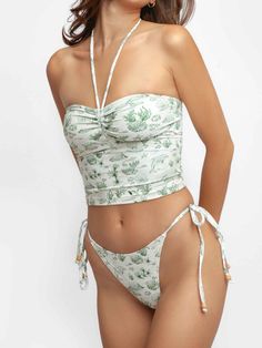 The bandeau-cut top can be worn strapless or as a halter neck top with its adjustable ties above the bust. The classic side-tie bottoms elevated with modern details feature a minimal silhouette with adjustable ties for a desired fit. Color: Green Scrunched front Wooden bead detail Fits true to size (U.S. Women’s sizes) Blackbough Swim, Lost Treasure, Crop Top Dress, Cute Bathing Suits, Mens Swim Shorts, Halter Neck Top, Cute Swimsuits, Tankini Top, Halter Neck