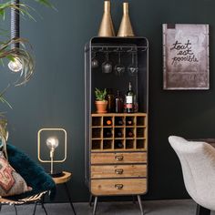 a tall cabinet with wine glasses and bottles on it next to a chair in a living room