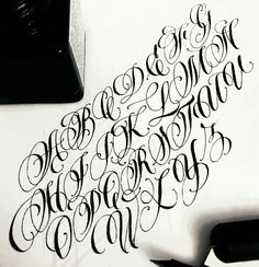 the letters are black and white with some type of writing on it's surface