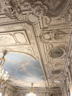 an ornately decorated room with chandeliers and paintings on the ceiling