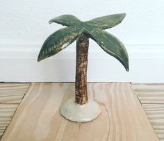 a small palm tree sitting on top of a wooden table