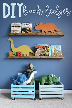 two wooden bookshelves with dinosaurs on them in front of a blue wall that says diy book ledges