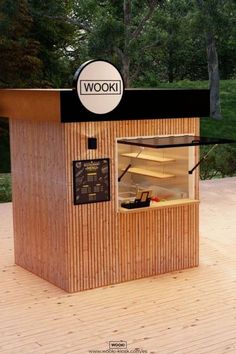 a wooden kiosk with a sign that says wooki