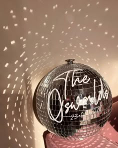 a disco ball sitting on top of a pink table