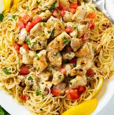 a white plate topped with pasta and chicken