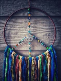 a colorful dream catcher hanging on a wooden wall