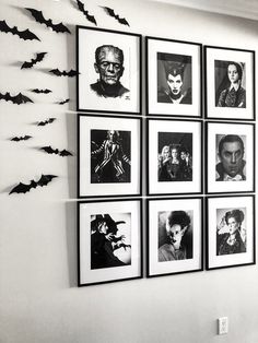 black and white photograph of halloween pictures on the wall with bats hanging from it's sides