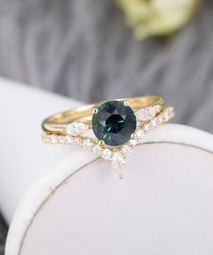 a close up of a ring with a green stone