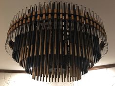 a chandelier made out of wooden pipes