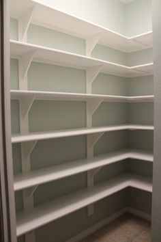 empty white shelves in the corner of a room