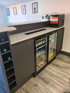 an open refrigerator with drinks in it and pictures on the wall behind it at a restaurant