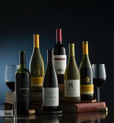 several bottles and glasses of wine on a table