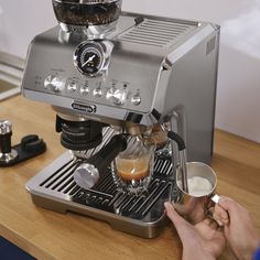 the espresso machine is being used by someone who has just finished their drink