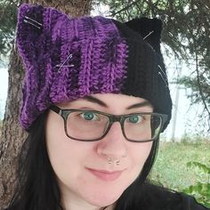 a woman wearing glasses and a knitted cat hat