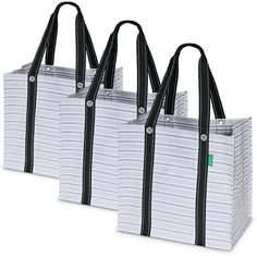 three white bags with black handles are lined up against each other on a white background