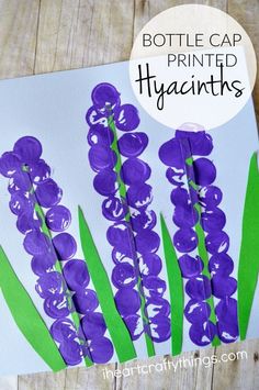 purple flowers painted on white paper with green stems